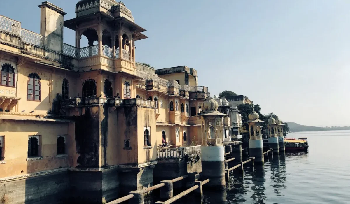 yellow painted buildings near body of water view during daytime